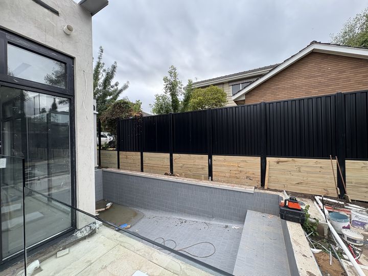 Colorbond boundary fence beside a pool by HD Fencing