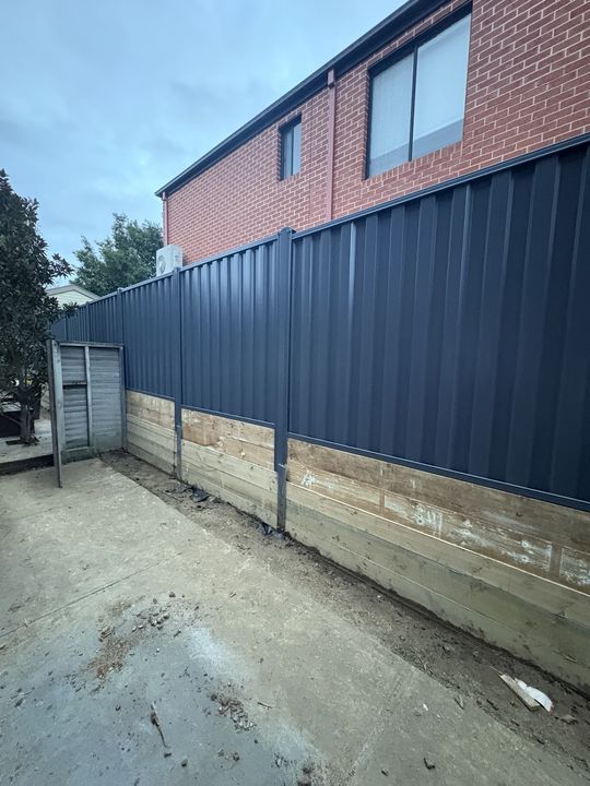 Colorbond fence beside a brick home by HD Fencing