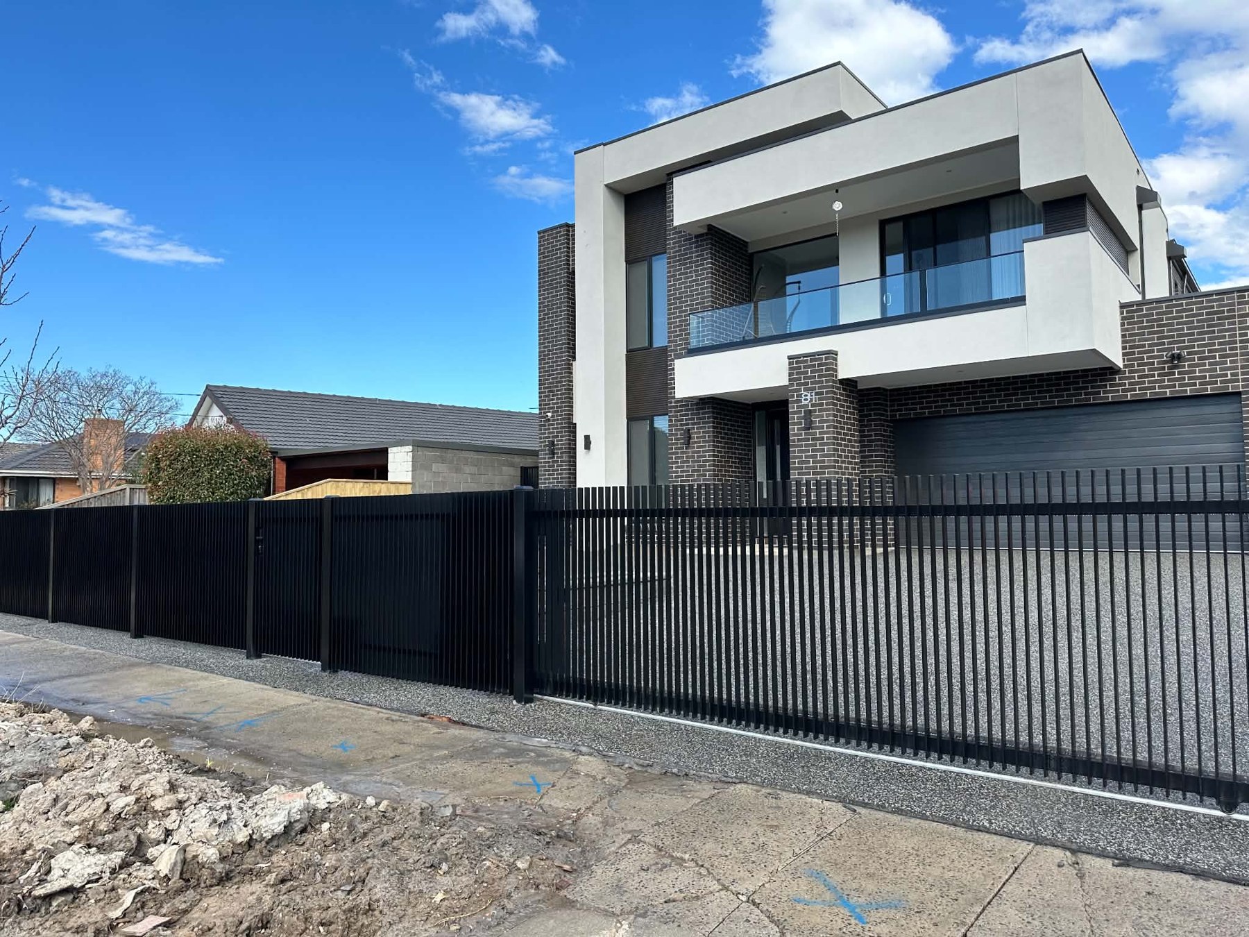 Black vertical front fence installed by HD Fencing outside a modern Melbourne home