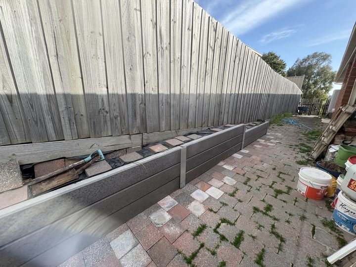 Retaining wall beside a new fence by HD Fencing